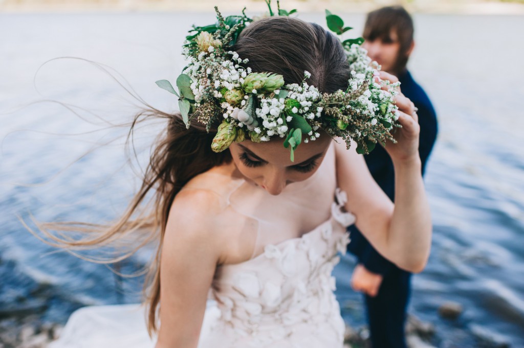 beautiful young couple just married on a walk by the lake